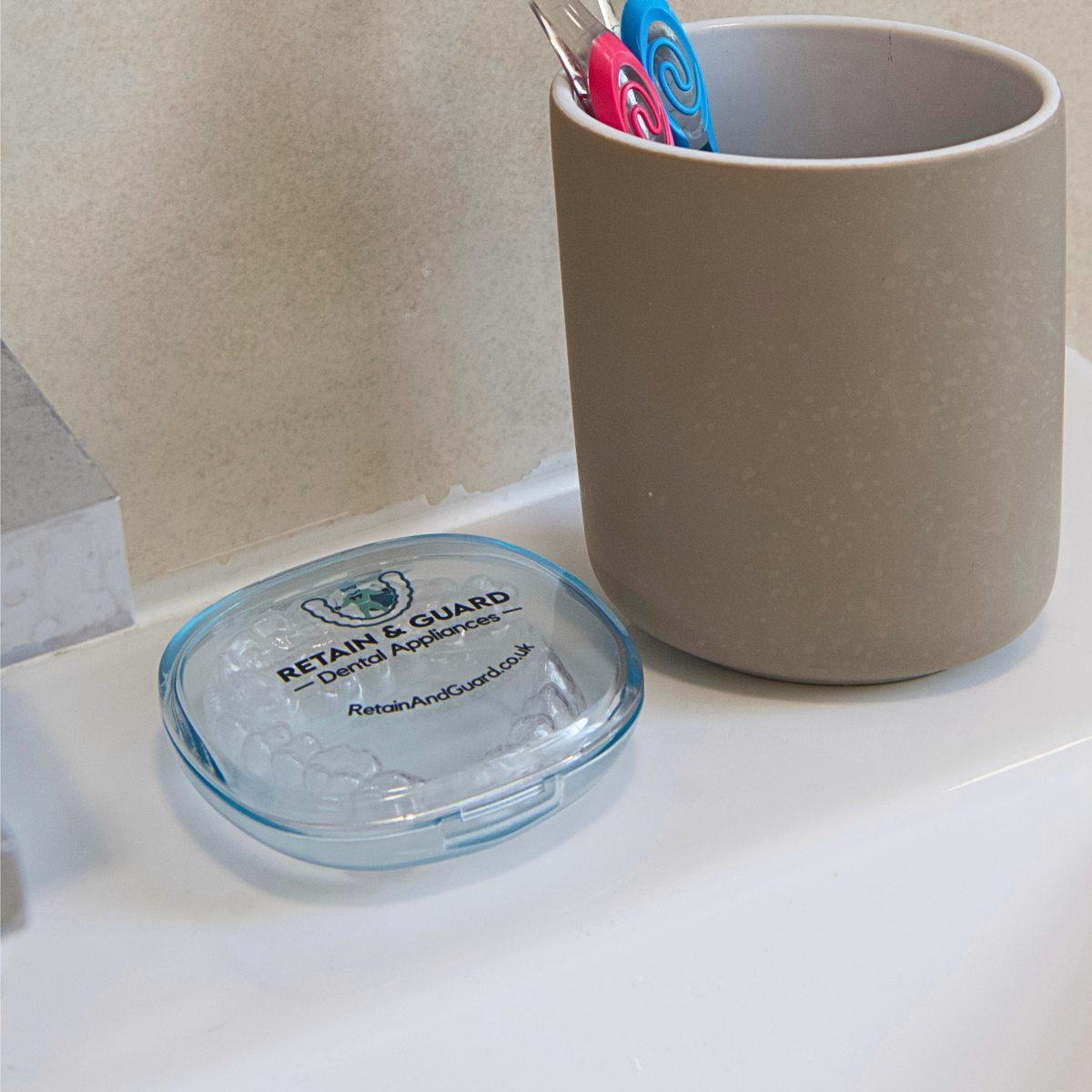 Closed Retain & Guard case protecting custom dental retainers
