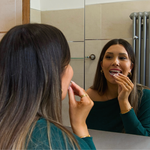Fitting a custom clear Essix retainer over the upper teeth
