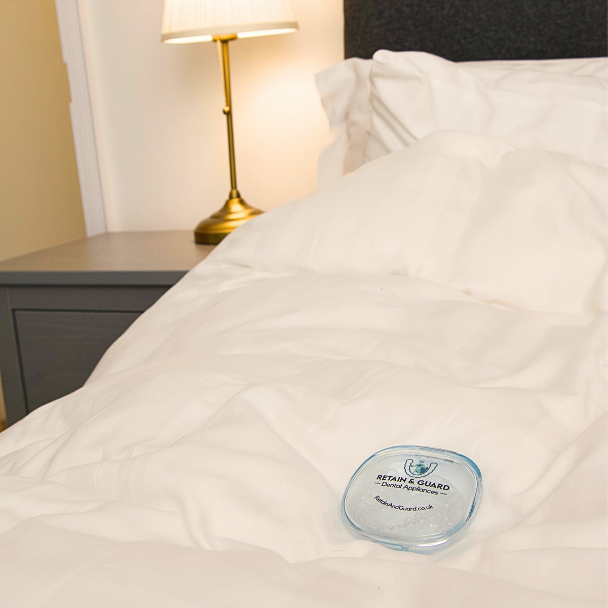 Retain & Guard retainer case placed beside a bed