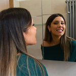 Woman smiling while wearing discreet clear dental retainers
